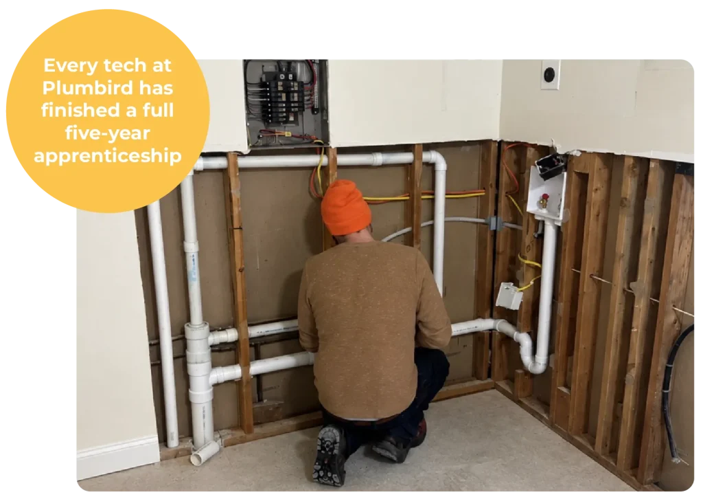 Plumber installing bathtub grab bar during residential plumbing service in Cleveland